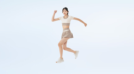 Obraz premium ジャンプするスポーツウェアの女性の全身写真（切り抜き背景透過PNGも販売しております。↓作成者リンクから「PNG」で検索してください）