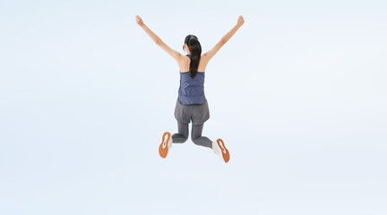 Full-body photo of a woman in sportswear jumping from behind. (We also sell PNGs that are cropped and have transparent background. Please search for "PNG" from the creator link.)
