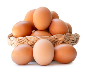 Many brown chicken eggs in stack in wicker basket isolated on white background with clipping path