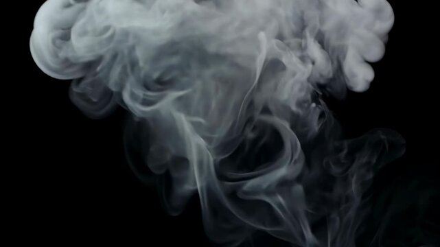 Thin wisps of white smoke curling over black background create moody abstract patterns of vapor and motion smoke cloud vapor plume black background