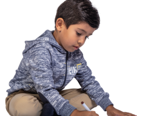 Young boy concentrating on a creative activity with focused expression transparent background