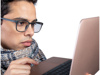 Focused man working on laptop late at night wearing glasses transparent background
