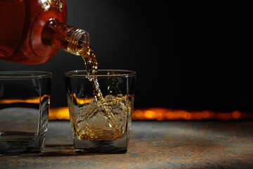 Whiskey is poured into a crystal glass.