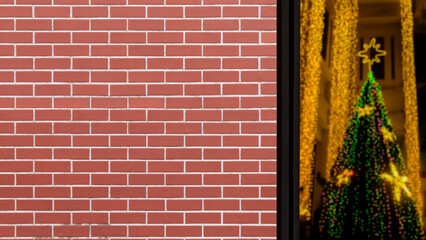 Beautiful old brown brick wall with blurred bokeh from brightness Chrismas tree outside clear window. 16:9 copy space format.
