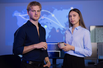 Cybersecurity professionals collaborating in SOC with real-time cyber threat maps