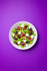 Salad with figs, feta cheese, pomegranate, and pecans. Healthy eating. Vegetarian food.