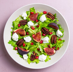 Salad with figs, feta cheese, pomegranate, and pecans. Healthy eating. Vegetarian food.