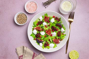 Salad with figs, feta cheese, pomegranate, and pecans. Healthy eating. Vegetarian food.