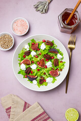 Salad with figs, feta cheese, pomegranate, and pecans. Healthy eating. Vegetarian food.