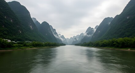 Tranquil River Flowing Through Misty Mountain Landscape