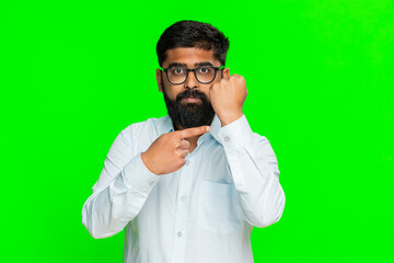 Indian man clenches fist in front with intense expression, showing strength, threat clear...