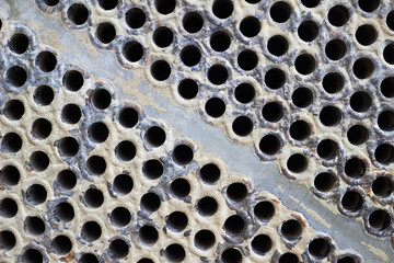 Tube sheet plate of heat exchanger or boiler closeup texture macro diagonal background full of...