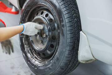 Mechanic changing a wheel of a modern car