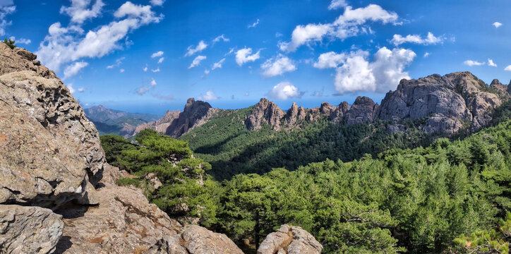 panoramic view of the impressive mountain backdrop of the Bavella massif in sunshine and a few white clouds