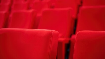 Naklejka premium Rows of vibrant red theater seats create a striking visual impact