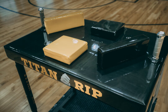 A professional arm wrestling table stands ready in a gymnasium, its pads and grips set up for the next match. 10.25. 2025 Valmiera, Latvia