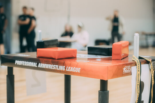 A professional arm wrestling table stands ready in a gymnasium, its pads and grips set up for the next match. 10.25. 2025 Valmiera, Latvia
