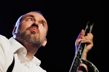 Low angle view of pensive actor standing near stepladder in theater 