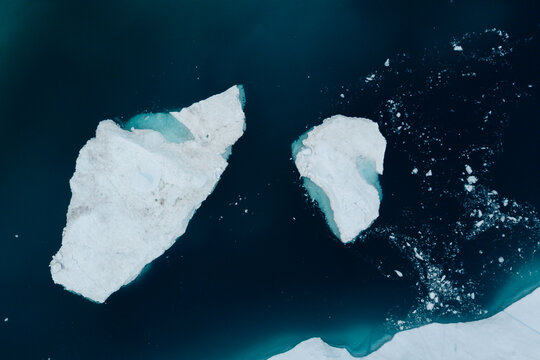 A stunning and surreal landscape unfolds in Greenland's UNESCO World Heritage Ilulissat Icefjord. Massive icebergs, freshly calved from the Sermeq Kujalleq glacier