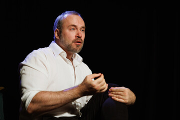 Actor playing role of drunk man isolated on black
