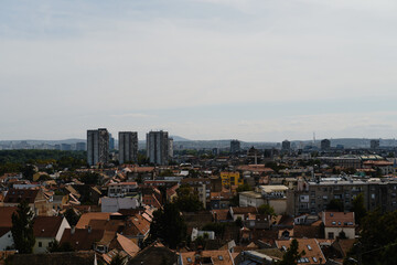 Urban skyline of Belgrade with high-rise buildings and rooftops in the foreground of Zemun