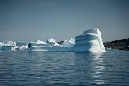 A stunning and surreal landscape unfolds in Greenland's UNESCO World Heritage Ilulissat Icefjord. Massive icebergs, freshly calved from the Sermeq Kujalleq glacier