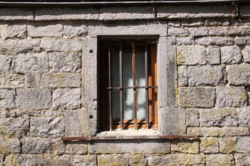 Old Window in Brick Wall
Weathered window framed by aged, cracked, and neglected bricks.
