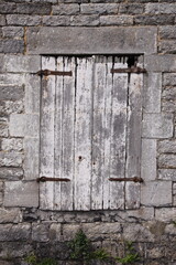 Old Window in Brick Wall
Weathered window framed by aged, cracked, and neglected bricks.
