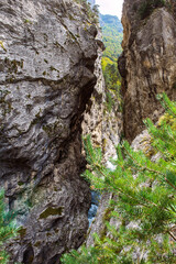 Beautiful mountain view with flowing river in the deep narrow valley, in ravine. Wild and beautiful nature of Caucasus, Russia