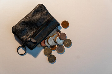 A black purse with coins in it