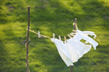 Washed clothes drying on a clothesline in the yard