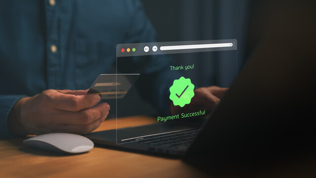 Person holding a credit card and making an online transaction on a laptop, with a digital “Payment Successful” message displayed, symbolizing secure online payment, ecommerce, and digital finance.