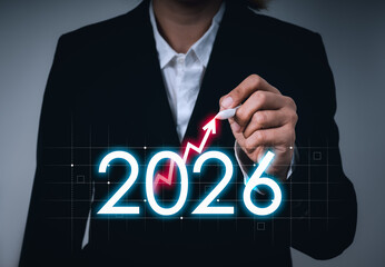 Businesswoman hand drawing red upward arrow over 2026 new year number, symbolizing financial growth, investment opportunities, economic forecast, rising debt, and future market strategy for success.