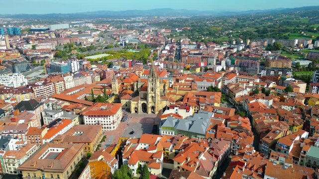 Aerial view of Oviedo's historic center, featuring the magnificent Oviedo Cathedral under clear autumn skies. A vibrant blend of ancient architecture and modern urban life.