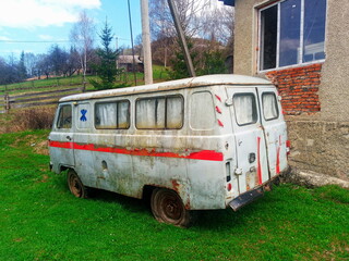 Abandoned old ambulance van in rural yard
