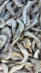 Raw shrimp piled together display seafood freshness and texture for cooking or culinary background