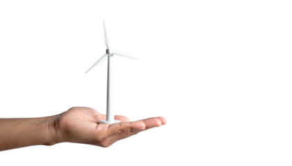 A hand holding a model wind turbine, representing sustainable energy