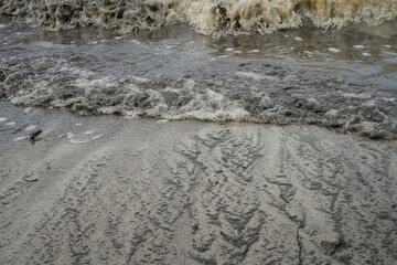 coastal beach shoreline with crashing waves on wet sand
