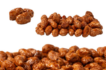 Tasty sweet roasted peanuts isolated on a white background.