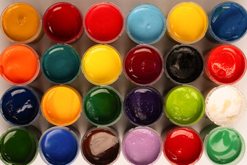 Gouache colorful paints set. Jars of gouache paint isolated on a white background.