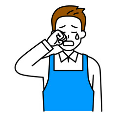 泣くエプロン姿の男性