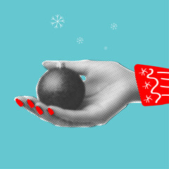 Female hand holding christmas ball in retro halftone style,trendy collage element cut out from paper
