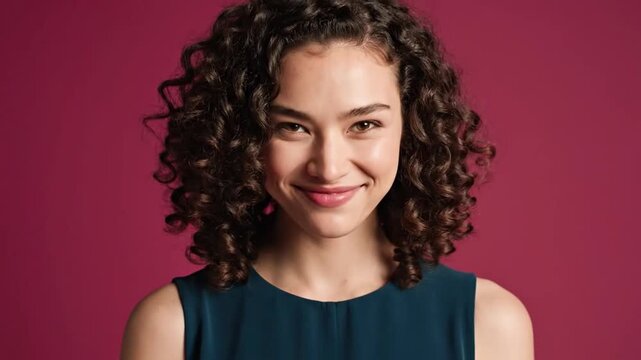 Shy woman breaking into a genuine laugh during a photo shoot