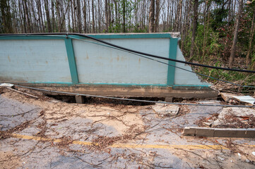 The wall and road collapse due to an earthquake in Chiang Rai province of Thailand. Earthquake causes the building to move with greater amplitude until some part of the building collapses or fails.