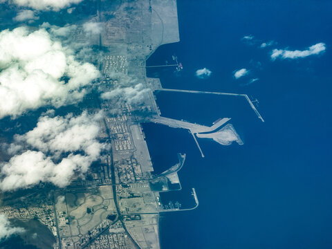 aerial landscape view of coastline in Fujairah, located at Gulf of Oman, with Port of Fujairah, Fujairah Oil Industry Zone, streets, buildings and other infrastructure