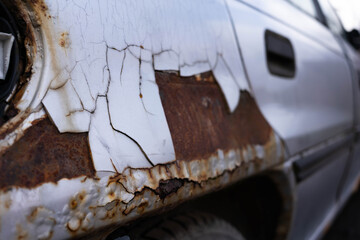 Rust detail on abandoned car near roadside in Transylvania, Romania.