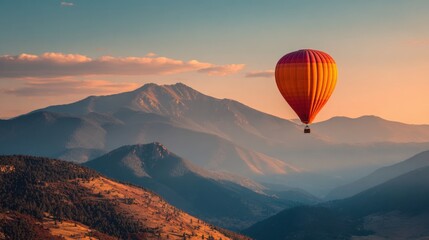 Obraz premium A vibrant hot air balloon soars high above stunning mountains during early morning light.