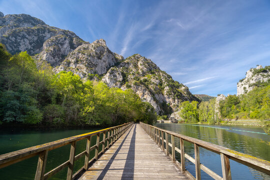 Wooden bridge over the Valdemurio reservoir in autumn. Bear Trail. Quir&oacute;s, Asturias, Spain