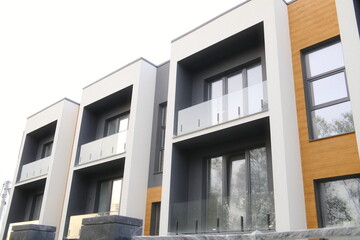 Exterior shows multiple floors, balconies, windows, and modern architecture.