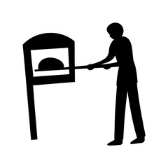 Silhouette of a baker placing bread into a traditional brick oven